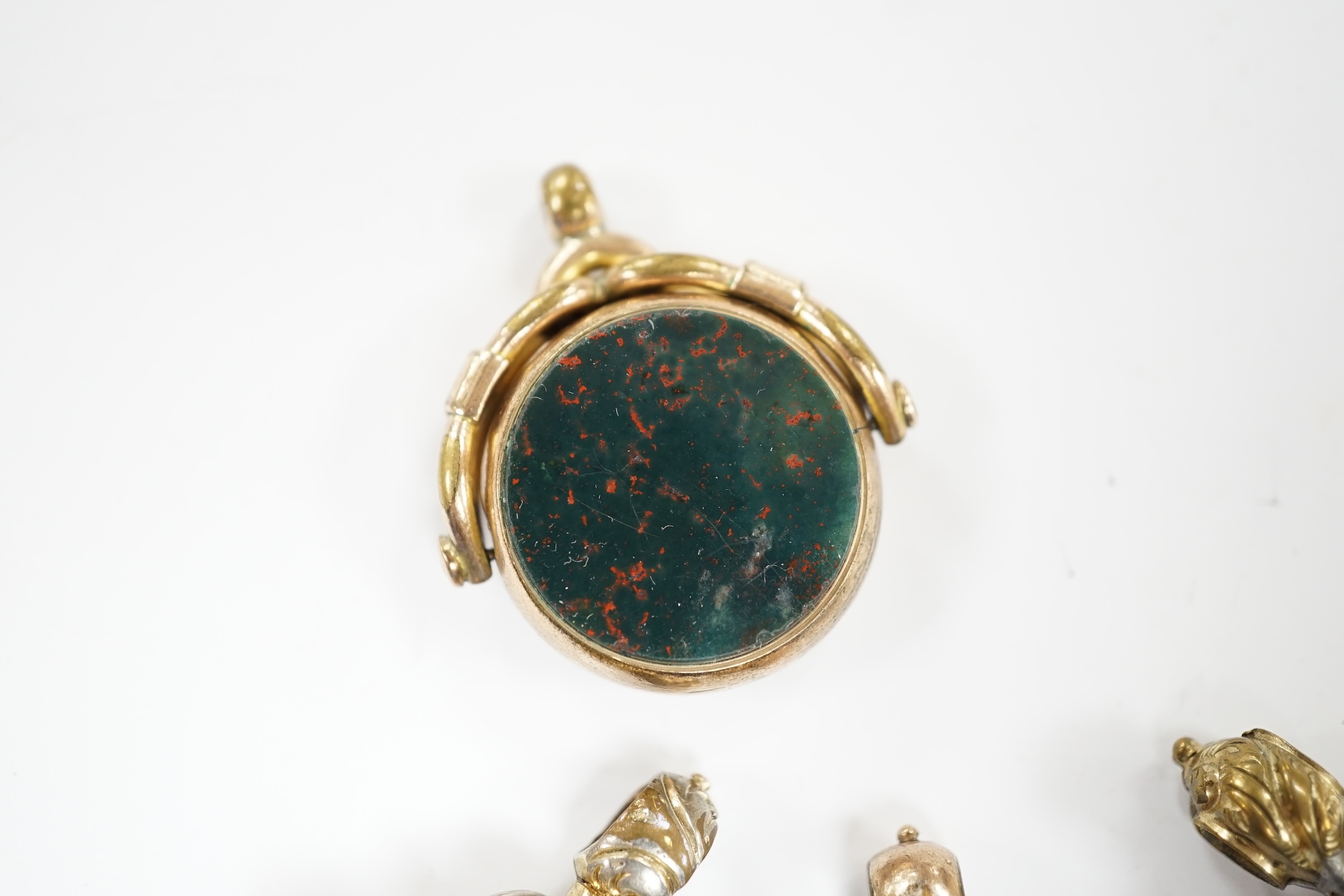 Four assorted 19th century fob seals including a 9ct and chalcedony set spinning fob, 32mm.